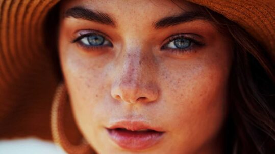 close up of a woman's face with glowing skin.